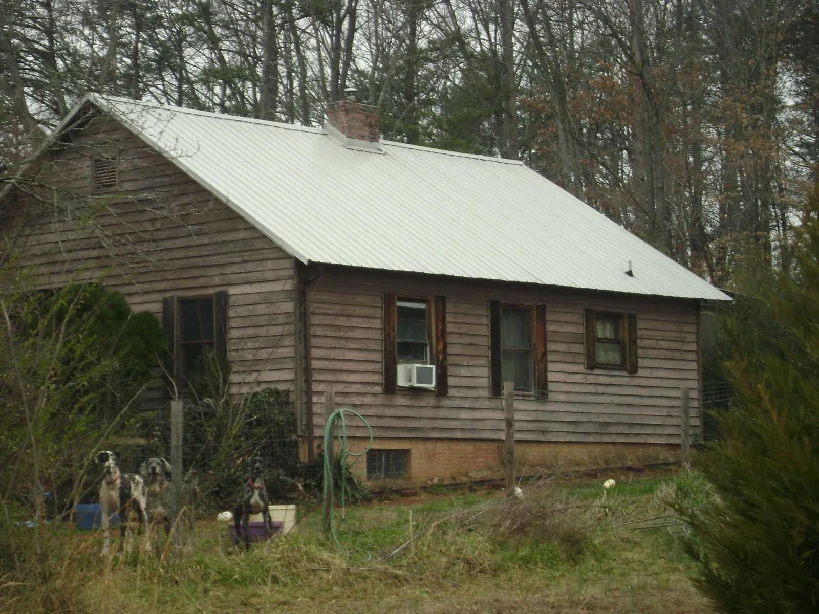 White metal roof on an old wood sided farmhouse, from a Metal Roof Installation job in Lockwood